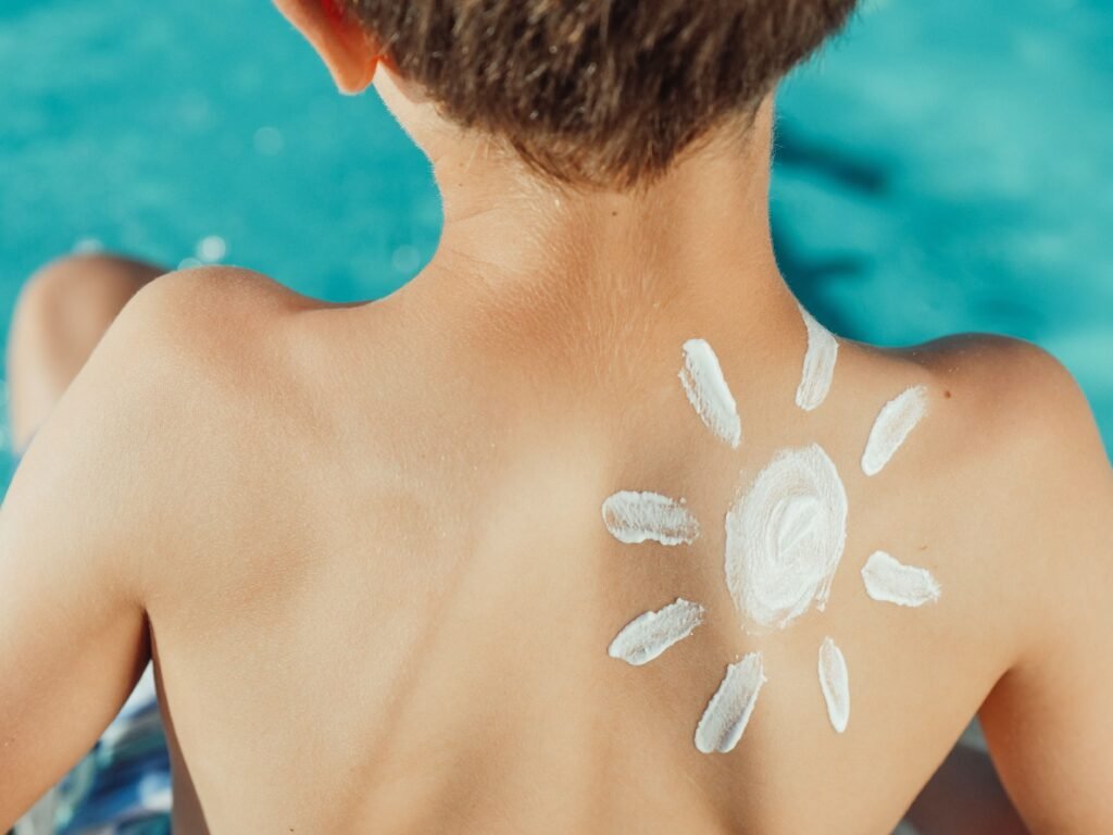 pexels-photo-8276909-8276909 Child's back with sunscreen in sun shape, enjoying a sunny day by the pool.